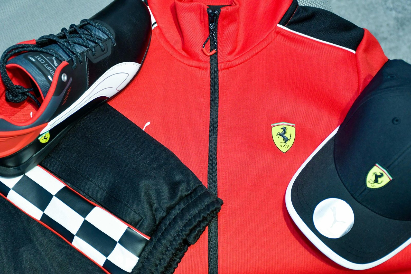 Close-up of red and black sportswear featuring iconic logos, highlighting fashion and style.